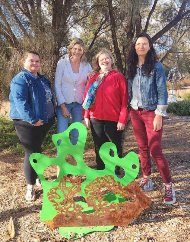 4 woman stand in front of a green and bronze sculpture. They include PLAET grant recipients from Tutti Arts and Foundation Barossa EO. 