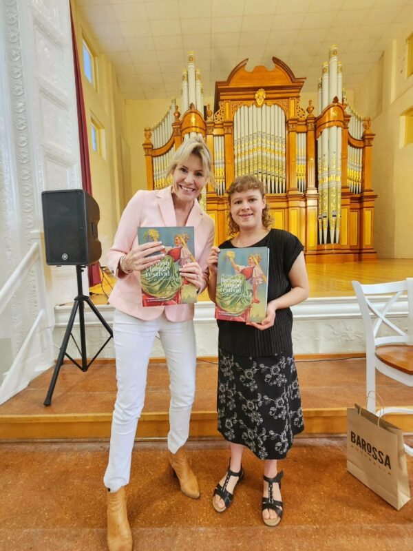 Foundation Barossa Executive Officer and Rebecca Rosenzweig hold up copies of Rebecca's book on the history of the Vintage Festival
